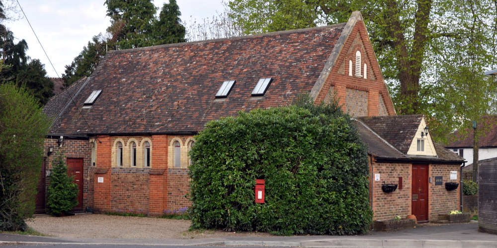 A single-storey brick building with a steep tiled roof