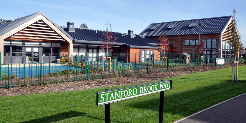 A modern, single-storey building with a street sign reading Stanford Brook Way